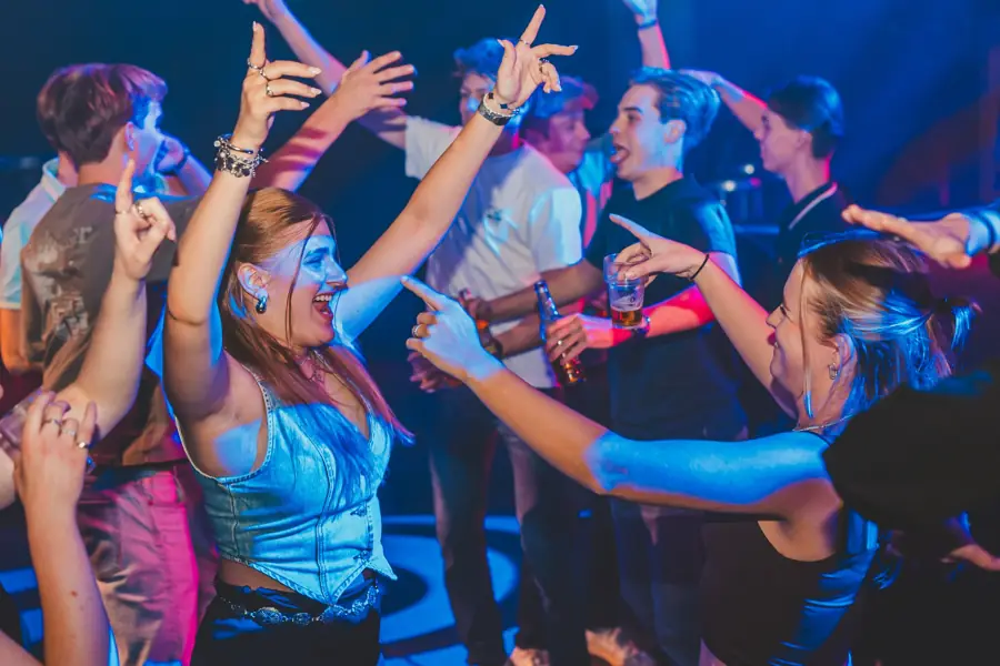 Groep danst en wijst naar elkaar
